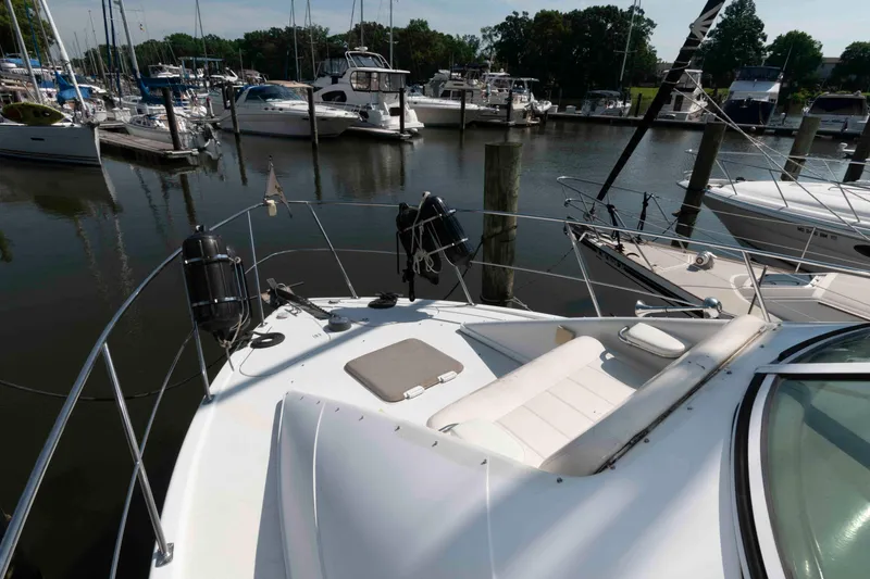 Slide: The Image of 1997 Carver 350 Mariner yacht docked at marina, surrounded by other boats. - 6