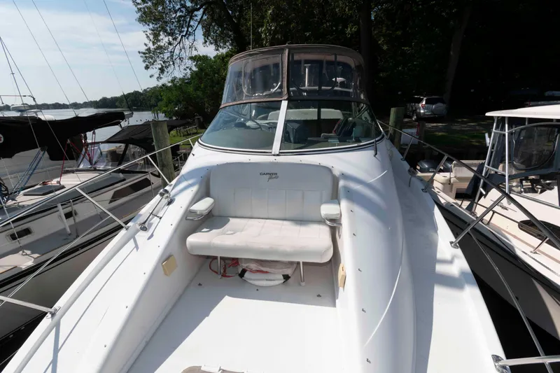 Slide: The Image of 1997 Carver 350 Mariner boat docked, featuring spacious deck and seating area. - 7