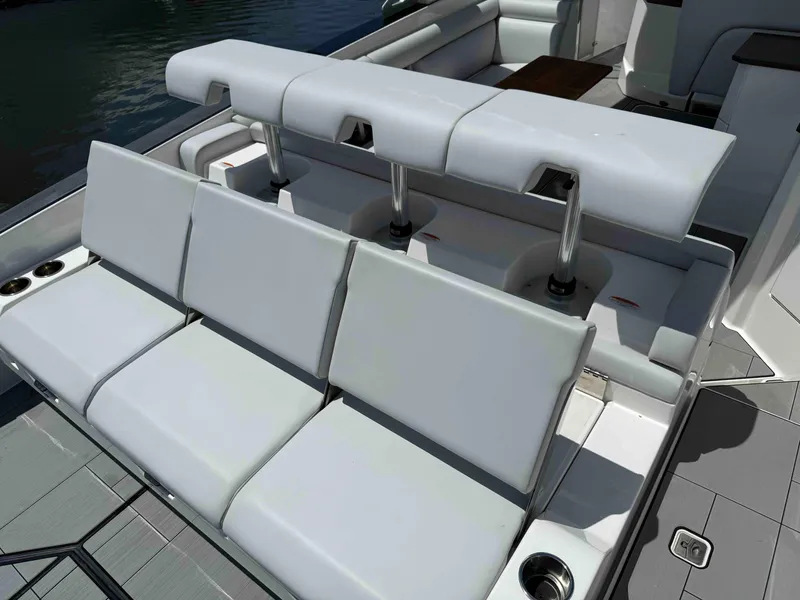 Slide: The Image of 2023 Aviara AV32 OB boat seating area with modern white upholstery and cup holders. - 10