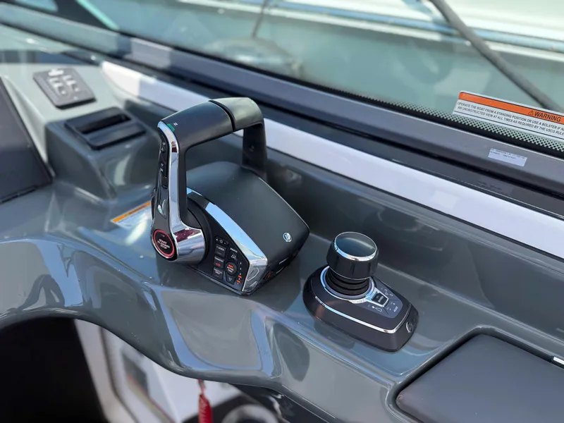Slide: The Image of 2023 Aviara AV32 OB boat controls with joystick and throttle on dashboard. - 15