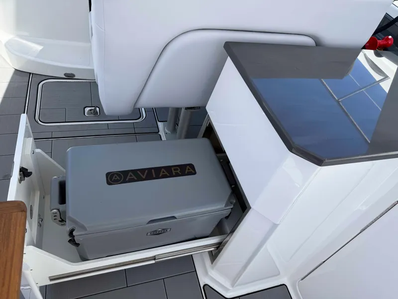 Slide: The Image of 2023 Aviara AV32 OB boat interior with built-in cooler storage. - 17