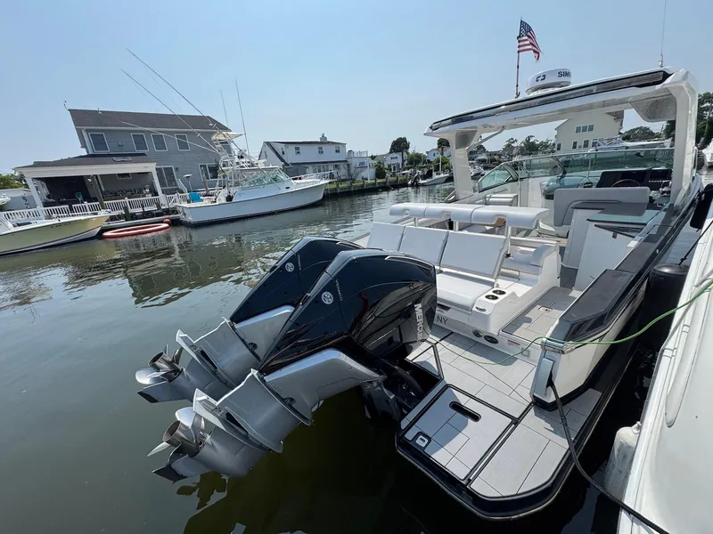 Slide: The Image of 2023 Aviara AV32 OB boat docked, featuring dual outboard engines and spacious seating. - 27