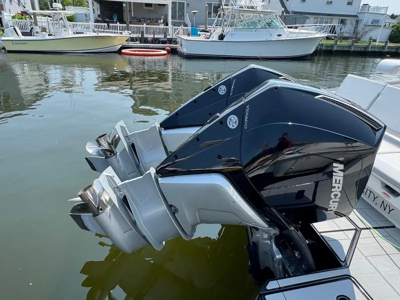Slide: The Image of Twin Mercury outboard engines on a 2023 Aviara AV32 OB boat docked by the water. - 28