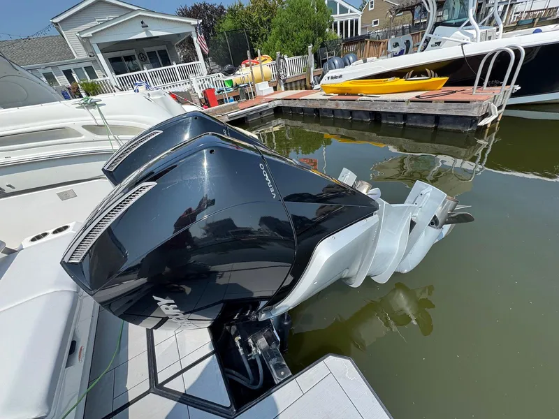 Slide: The Image of 2023 Aviara AV32 OB boat with dual Mercury outboard engines docked at a marina. - 29