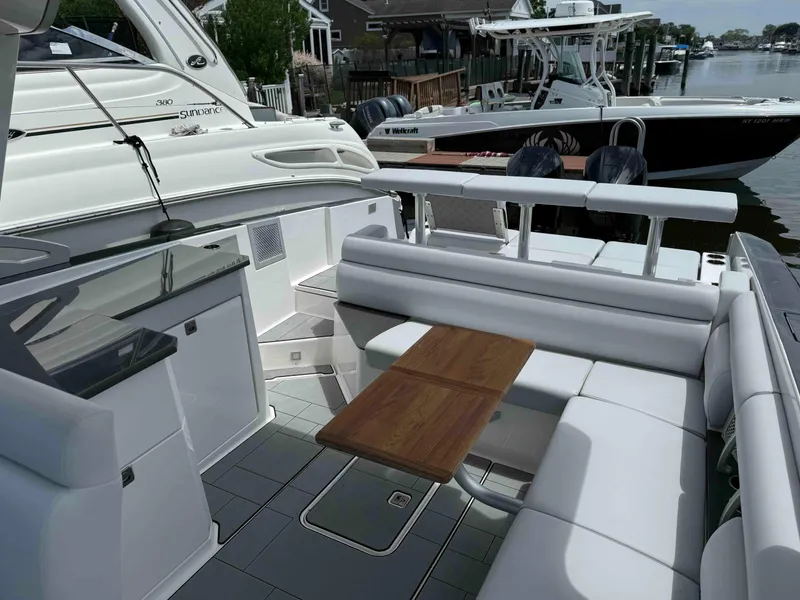 Slide: The Image of 2023 Aviara AV32 OB luxury boat interior with seating and wooden table. - 3