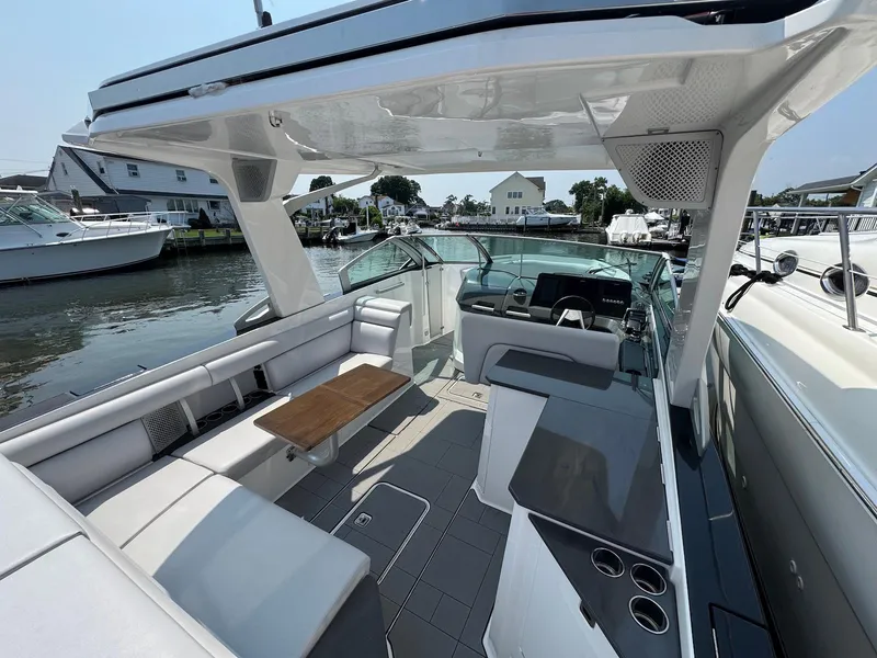 Slide: The Image of 2023 Aviara AV32 OB luxury boat interior with seating and helm, docked at marina. - 6