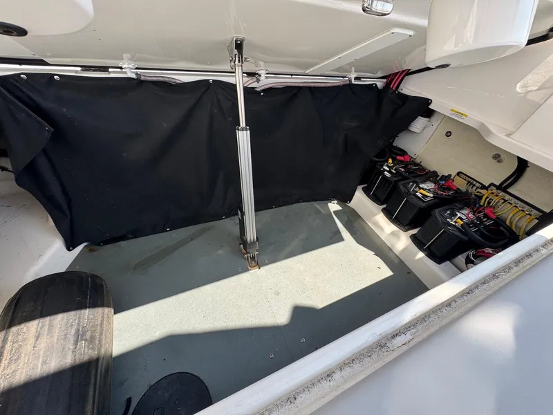 Slide: The Image of 2023 Aviara AV32 OB boat storage compartment with batteries and wiring. - 7