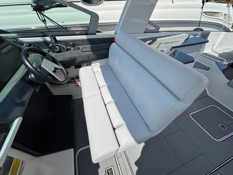 Slide: The Image of 2023 Aviara AV32 OB boat interior with white seating and modern dashboard. - 8