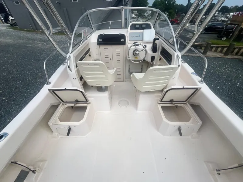Slide: The Image of 2006 Grady-White Adventure 208WA boat interior with helm, seating, and storage compartments. - 10