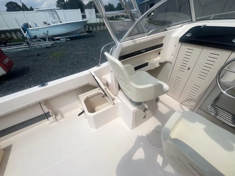 Slide: The Image of 2006 Grady-White Adventure 208WA boat interior with seating and storage compartments. - 11