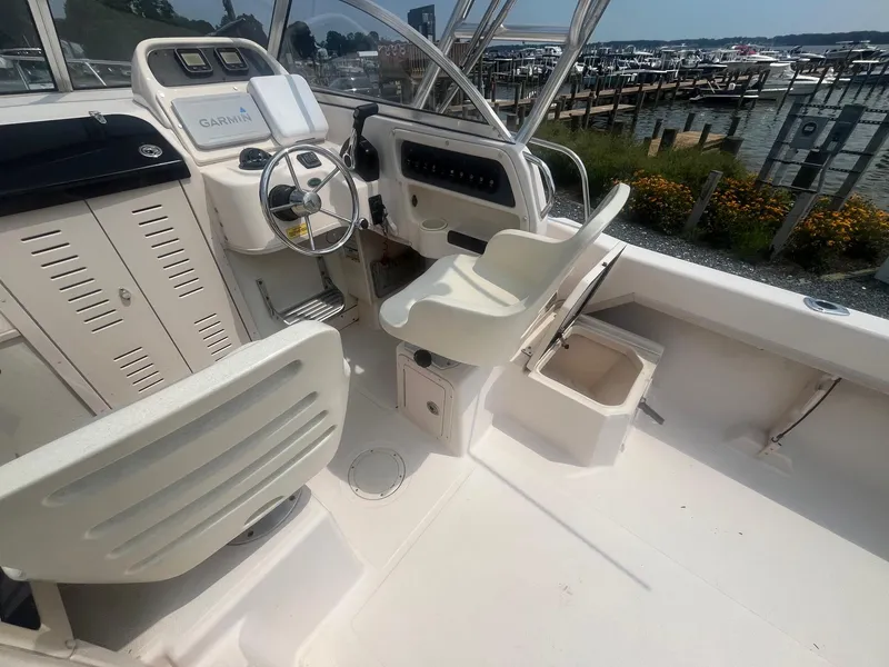 Slide: The Image of 2006 Grady-White Adventure 208WA boat interior with steering wheel and seating. - 12