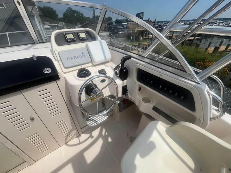 Slide: The Image of 2006 Grady-White Adventure 208WA boat helm with Garmin navigation system and steering wheel. - 13