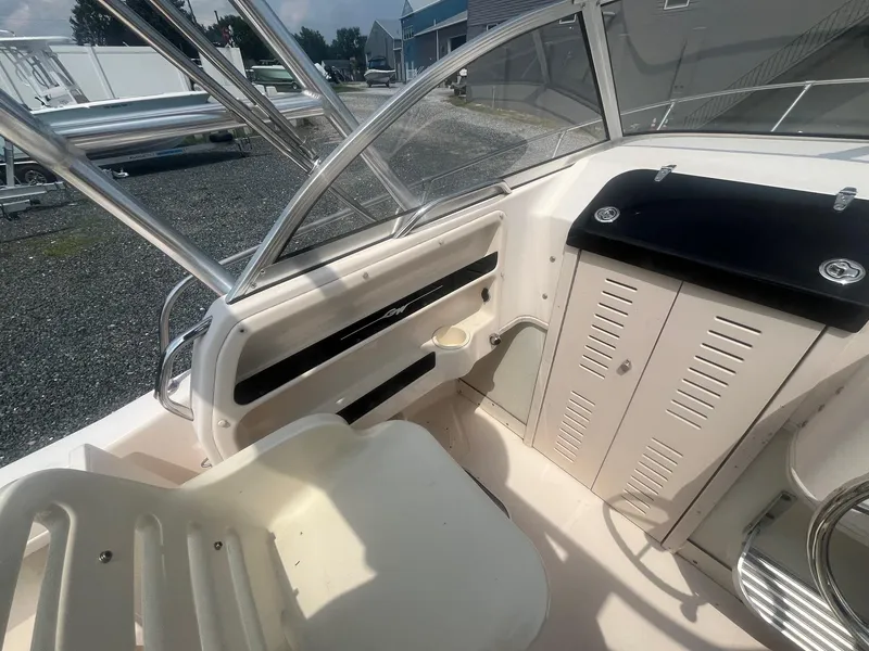 Slide: The Image of 2006 Grady-White Adventure 208WA boat interior with seating and storage compartments. - 14