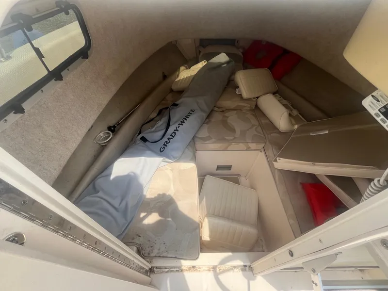 Slide: The Image of 2006 Grady-White Adventure 208WA cabin interior with seating and storage. - 17