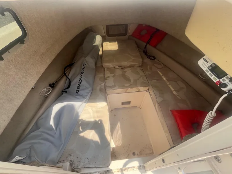 Slide: The Image of 2006 Grady-White Adventure 208WA cabin interior with cushions and safety equipment. - 19