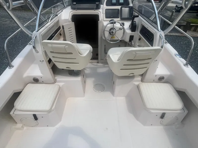 Slide: The Image of 2006 Grady-White Adventure 208WA boat interior with helm and seating. - 21