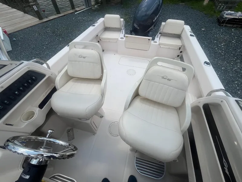 Slide: The Image of 2006 Grady-White Adventure 208WA boat interior with seating and steering wheel. - 22