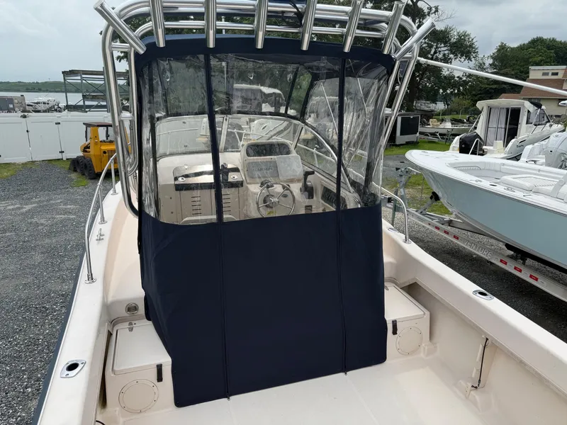 Slide: The Image of 2006 Grady-White Adventure 208WA boat with covered cockpit, parked outdoors. - 24