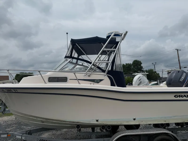 Slide: The Image of 2006 Grady-White Adventure 208WA boat on trailer, overcast sky background. - 25