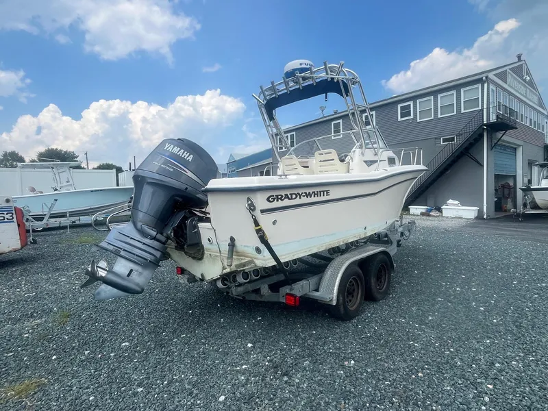 Slide: The Image of 2006 Grady-White Adventure 208WA boat with Yamaha engine on trailer, parked outdoors. - 3