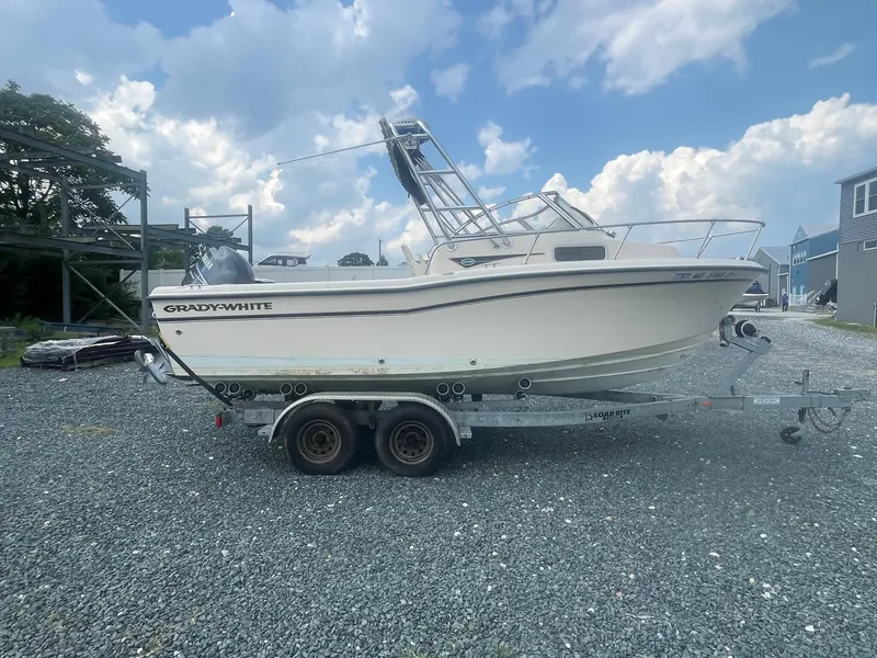 Slide: The Image of 2006 Grady-White Adventure 208WA boat on trailer under cloudy sky. - 4