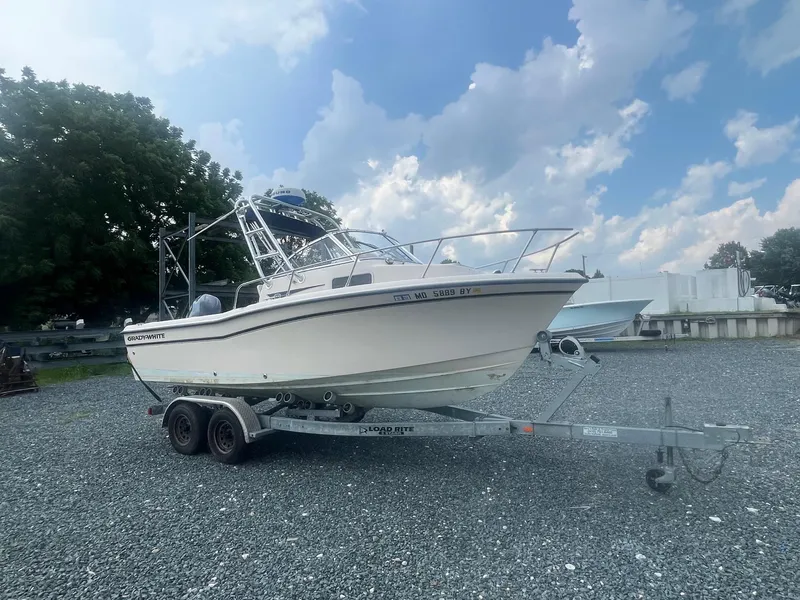 Slide: The Image of 2006 Grady-White Adventure 208WA boat on trailer under a partly cloudy sky. - 5