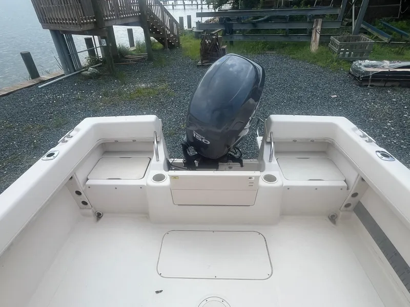 Slide: The Image of 2006 Grady-White Adventure 208WA boat interior with outboard motor, dockside view. - 6