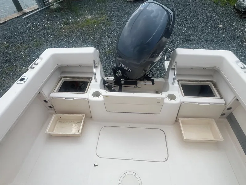 Slide: The Image of 2006 Grady-White Adventure 208WA boat interior with motor and storage compartments. - 7