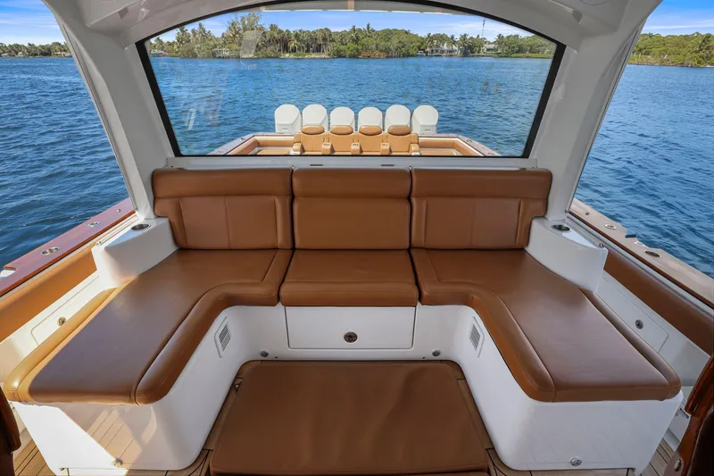 Slide: The Image of Luxurious seating on 2023 HCB 65 Estrella yacht, overlooking serene blue waters. - 14
