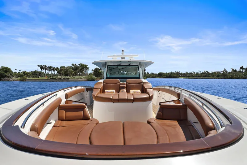 Slide: The Image of 2023 HCB 65 Estrella luxury boat with brown leather seating on a sunny day. - 31