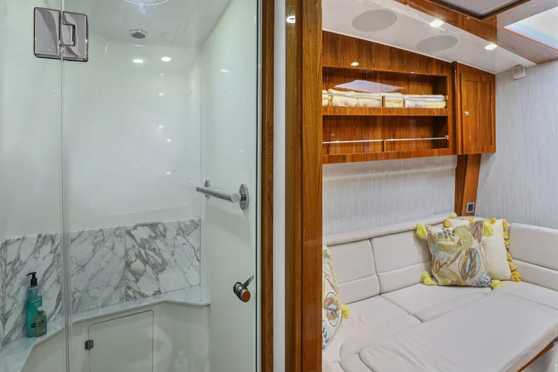 Slide: The Image of Luxurious interior of 2023 HCB 65 Estrella yacht featuring a modern shower and cozy seating area. - 41