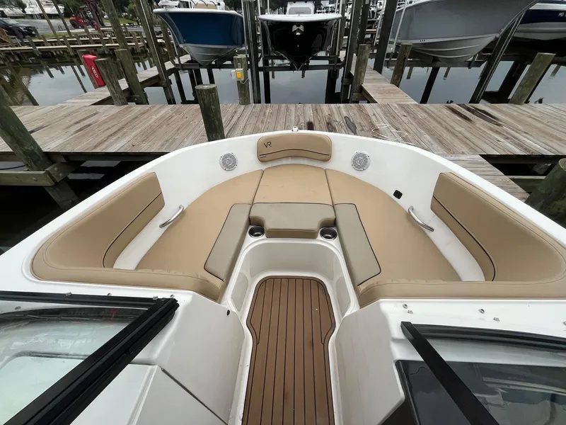 Slide: The Image of 2023 Bayliner VR6 Bowrider OB with tan seating, docked at a marina. - 11