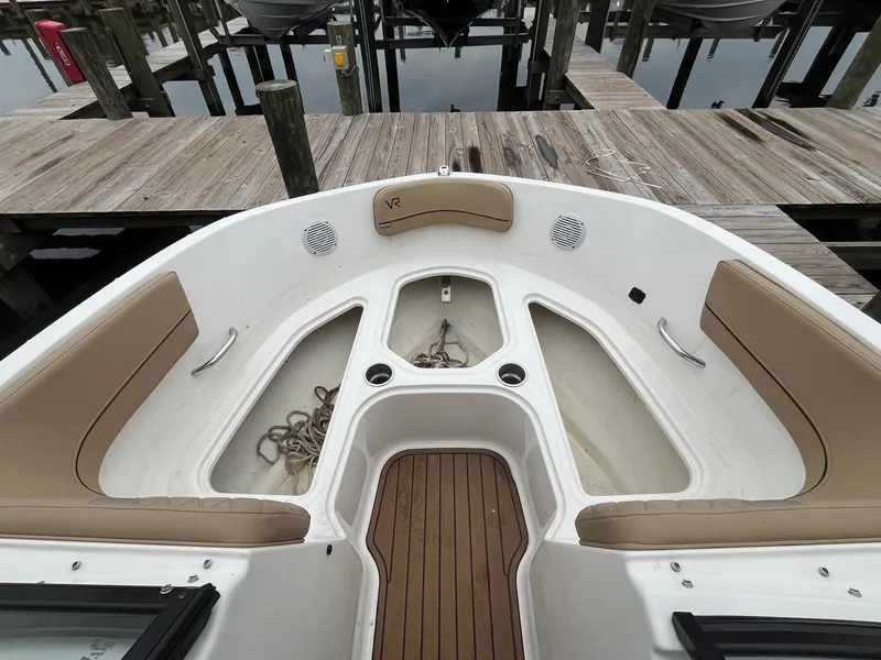 Slide: The Image of 2023 Bayliner VR6 Bowrider OB interior with tan seating and storage compartments. - 12