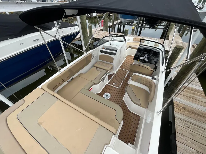 Slide: The Image of 2023 Bayliner VR6 Bowrider OB with spacious seating and sleek design at a dock. - 3