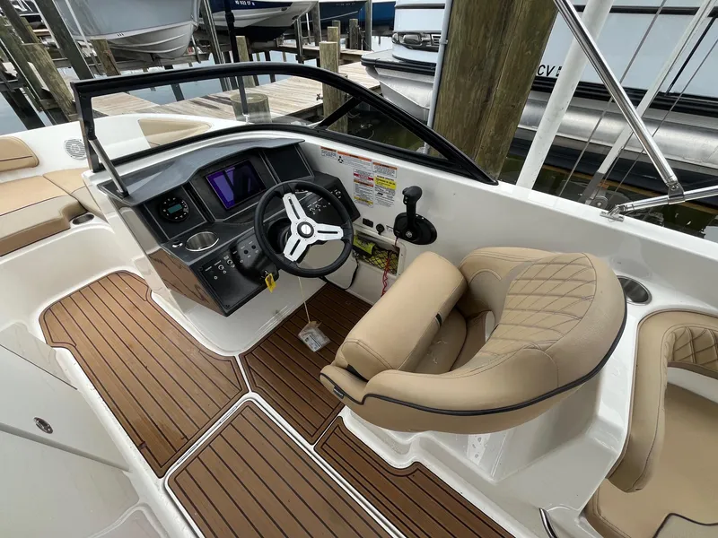 Slide: The Image of 2023 Bayliner VR6 Bowrider OB cockpit with modern steering and plush seating. - 8