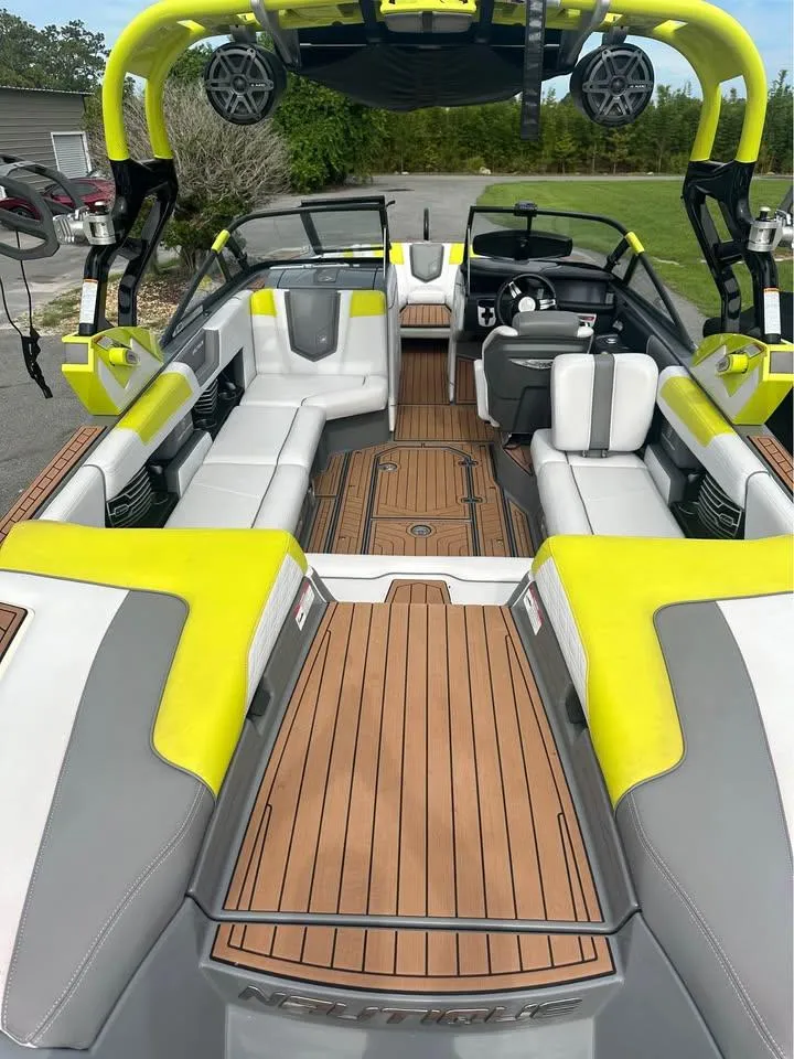Slide: The Image of 2017 Nautique Super Air Nautique G23 interior with vibrant seating and teak flooring. - 4