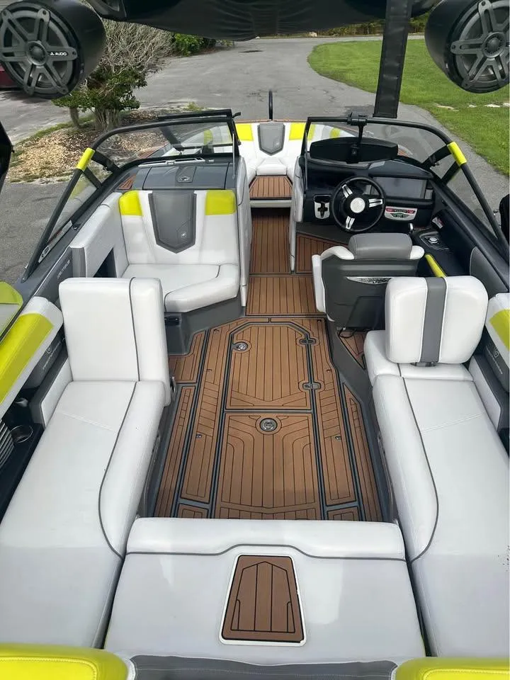 Slide: The Image of 2017 Nautique Super Air Nautique G23 interior with white seats and wood-style flooring. - 7