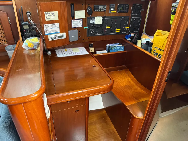 Slide: The Image of Navigation station on 1997 Beneteau Oceanis 461 yacht with control panels and wooden finish. - 10