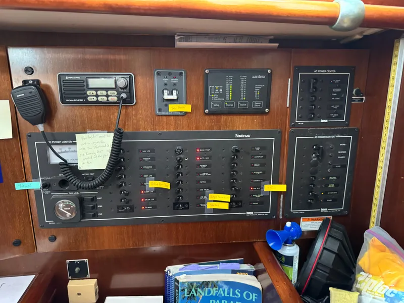 Slide: The Image of Electrical control panel of a 1997 Beneteau Oceanis 461 sailboat with various switches and labels. - 11