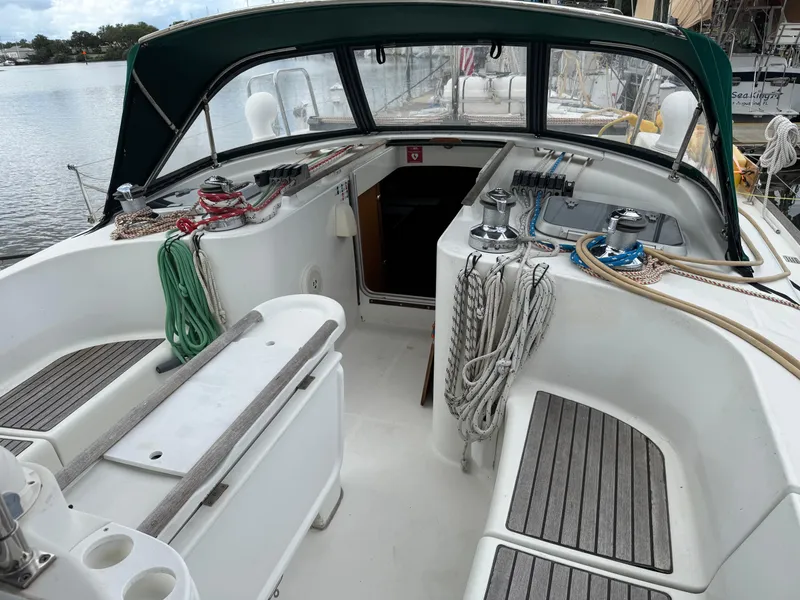 Slide: The Image of Cockpit of 1997 Beneteau Oceanis 461 sailboat with ropes and seating, docked by the water. - 30
