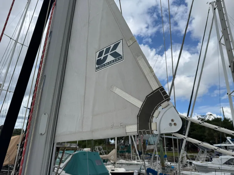 Slide: The Image of Close-up of a sail on a 1997 Beneteau Oceanis 461, featuring UK Sailmakers logo. - 31