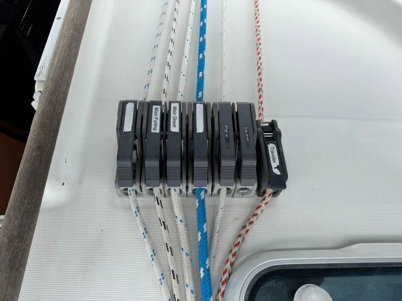 Slide: The Image of Rope clutches on a 1997 Beneteau Oceanis 461 sailboat deck, labeled for various functions. - 34