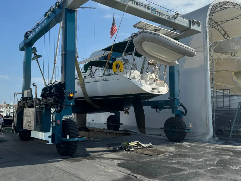 Slide: The Image of Beneteau Oceanis 461 sailboat from 1997 being lifted at a yacht yard. - 36