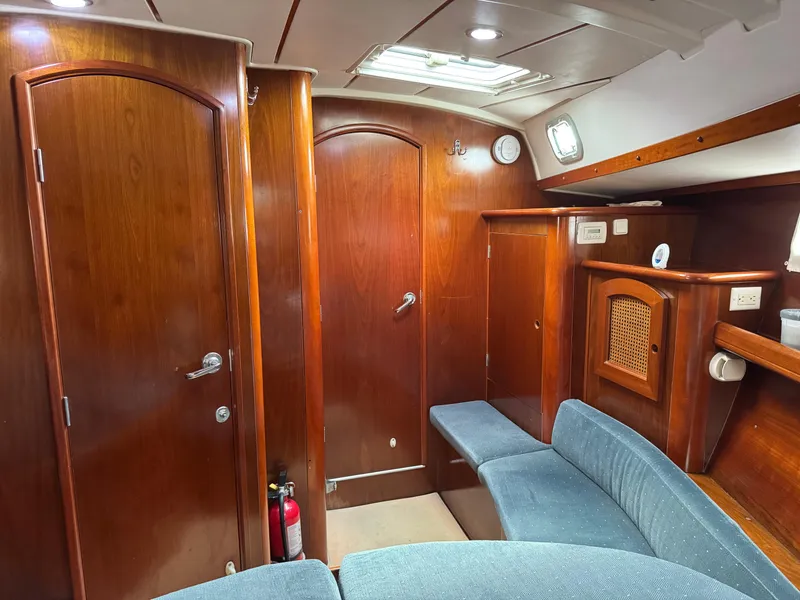 Slide: The Image of Interior of 1997 Beneteau Oceanis 461 yacht with wooden finish and blue seating. - 9