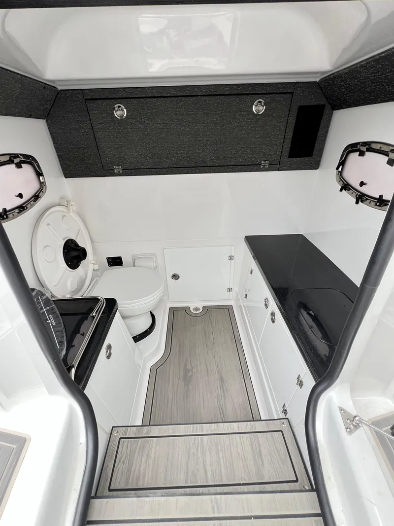 Slide: The Image of 2025 Monterey Elite 30 OB boat interior with modern bathroom and sleek cabinetry. - 10
