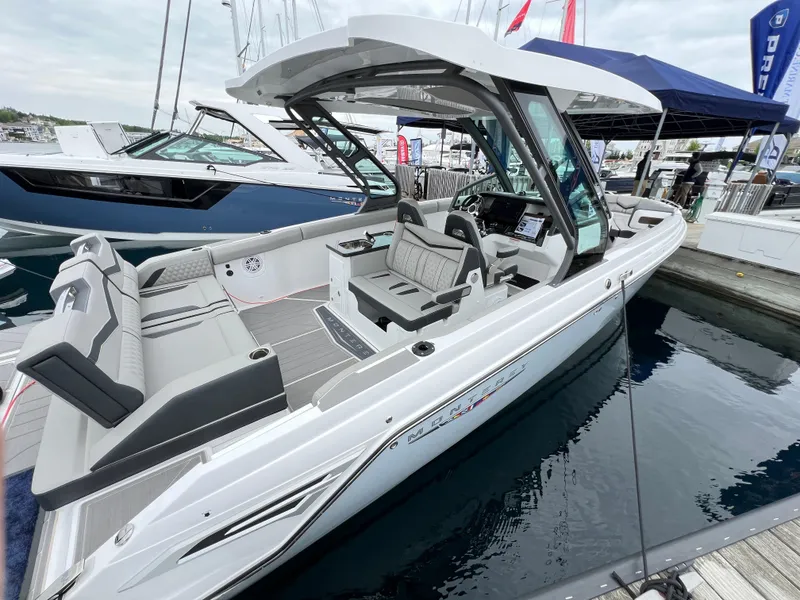 Slide: The Image of 2025 Monterey Elite 30 OB boat docked, featuring sleek design and spacious seating. - 3
