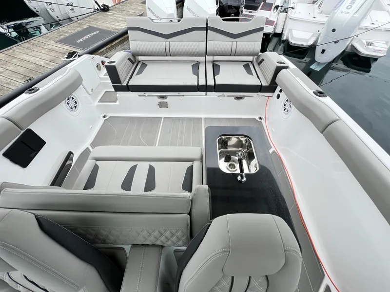 Slide: The Image of 2025 Monterey Elite 30 OB boat interior with luxurious seating and sleek design. - 4