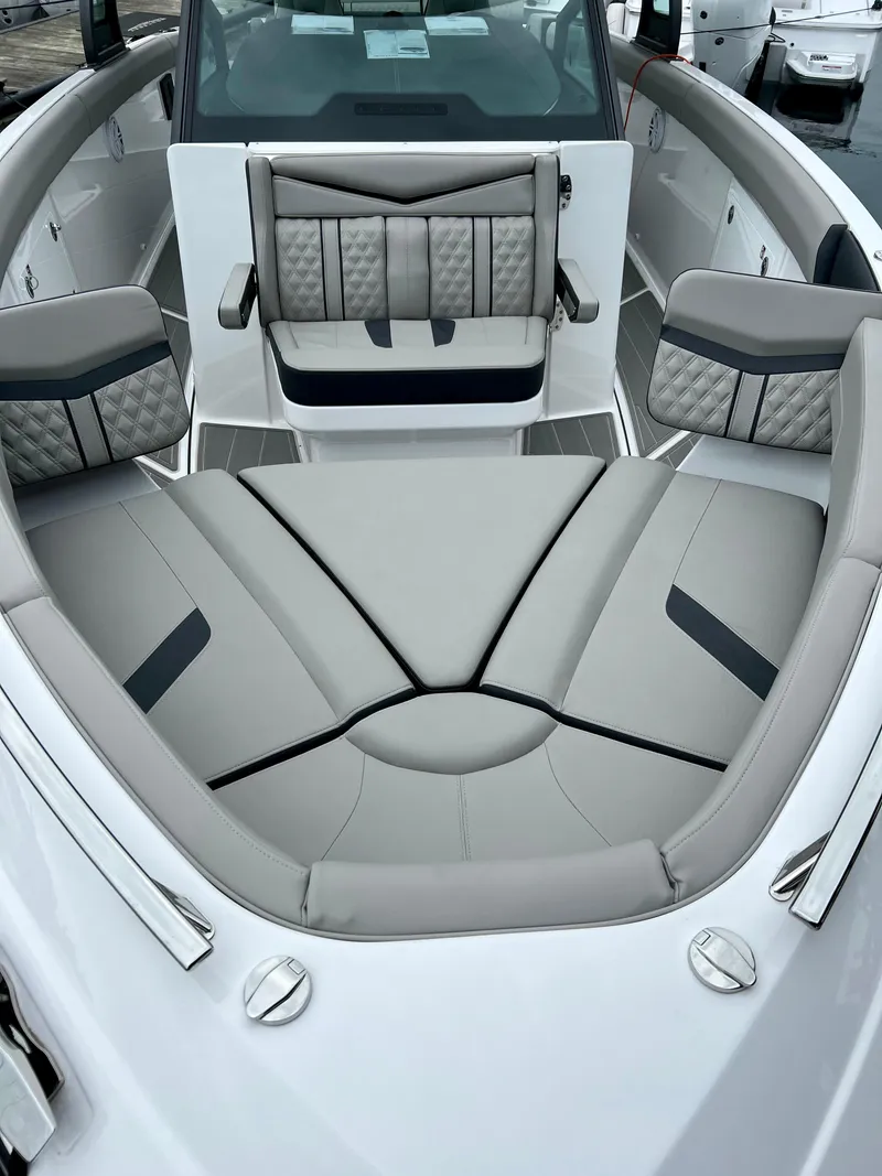 Slide: The Image of Luxurious seating area on 2025 Monterey Elite 30 OB boat, featuring elegant gray upholstery. - 9