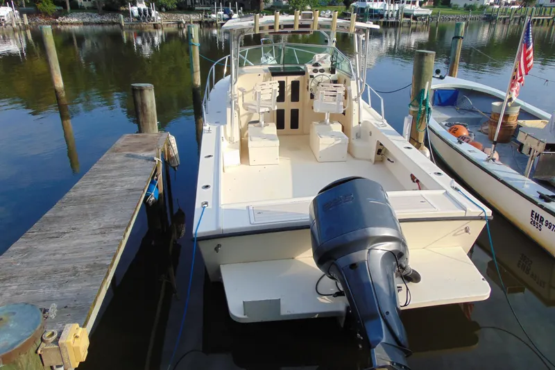 Slide: The Image of 2004 Parker Walkaround boat docked at marina with outboard motor. - 12