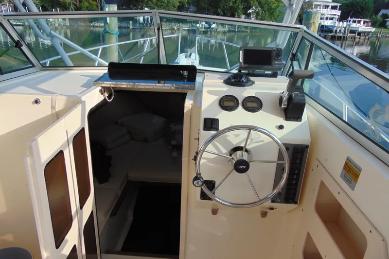 Slide: The Image of 2004 Parker Walkaround boat interior with steering wheel and cabin entrance. - 13